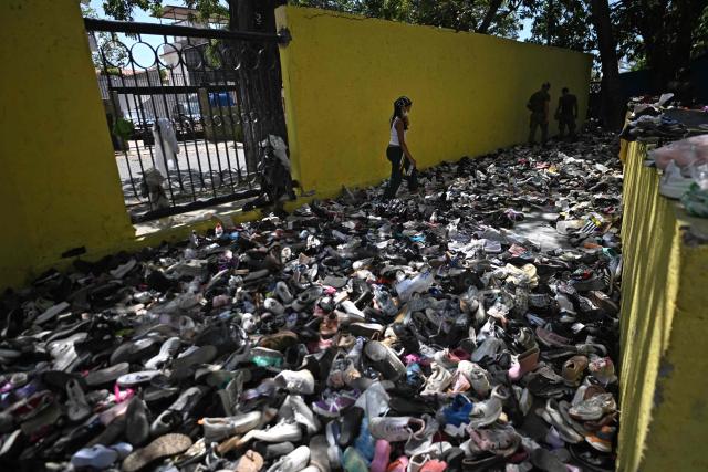 A woman walks amid clothes at a collection center in Caraballeda, La Guaira state, Venezuela, on July 1, 2026, following the June 24 twin earthquakes. Venezuelans, with help from around the world, were still searching on July 1, 2026 for survivors a week after massive earthquakes killed nearly 2,000 and left thousands unaccounted for. (Photo by Juan BARRETO / AFP)