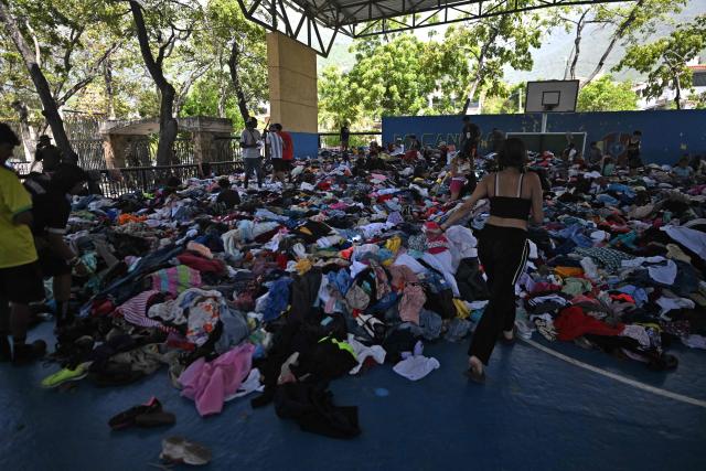 Residents look for clothes at a collection center in Caraballeda, La Guaira state, Venezuela, on July 1, 2026, following the June 24 twin earthquakes. Venezuelans, with help from around the world, were still searching on July 1, 2026 for survivors a week after massive earthquakes killed nearly 2,000 and left thousands unaccounted for. (Photo by Juan BARRETO / AFP)