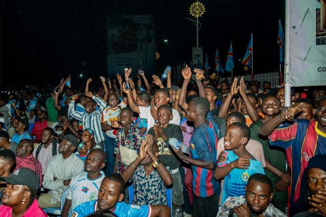 Democratic Republic of Congo supporters react as they watch the 2026 World Cup round of 32 football match between England and Democratic Republic of Congo on a giant screen at a fan zone in Kinshasa on July 1, 2026. (Photo by Hardy BOPE / AFP)