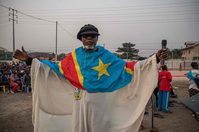A Democratic Republic of Congo supporter poses for a photograph as he watches the 2026 World Cup round of 32 football match between England and Democratic Republic of Congo on a giant screen at a fan zone in Kinshasa on July 1, 2026. (Photo by Hardy BOPE / AFP)