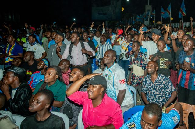 Democratic Republic of Congo supporters react as they watch the 2026 World Cup round of 32 football match between England and Democratic Republic of Congo on a giant screen at a fan zone in Kinshasa on July 1, 2026. (Photo by Hardy BOPE / AFP)