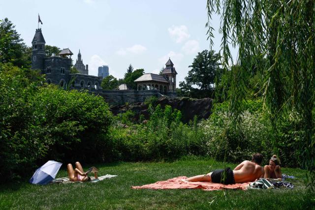People sunbathe in Central Park during a heatwave in New York City, on July 1, 2026. Tens of millions of Americans sweltered under furnace-like temperatures this week as central and eastern cities hunkered down for a heat wave set to last through the July 4 holiday weekend. Dozens of local temperature records could be broken, the National Weather Service (NWS) warned, with temperatures in many places to surpass 100 degrees Fahrenheit (38 degrees Celsius) and high humidity pushing the heat index as high as 115 degrees. (Photo by kena betancur / AFP)
