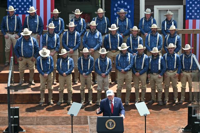 US President Donald Trump delivers remarks onstage, flanked by Rough Riders re-enactors, portraying the 1st United States Volunteer Cavalry, at the Burning Hills Amphitheatre after attending the opening of the Theodore Roosevelt Presidential Library in Medora, North Dakota, on July 1, 2026. (Photo by SAUL LOEB / AFP)