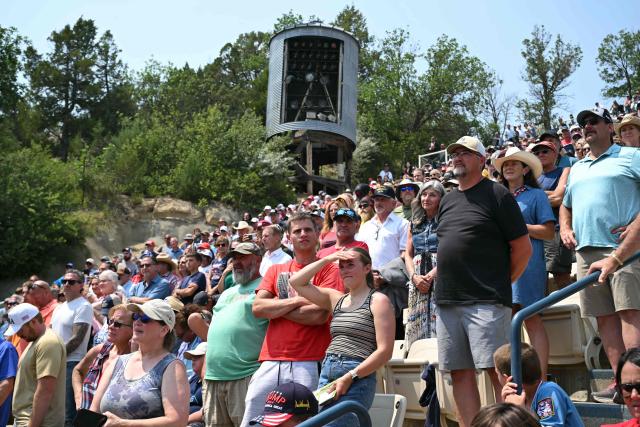 People listen as the US president speaks at the Burning Hills Amphitheatre after he attended the opening of the Theodore Roosevelt Presidential Library in Medora, North Dakota, on July 1, 2026. (Photo by SAUL LOEB / AFP)