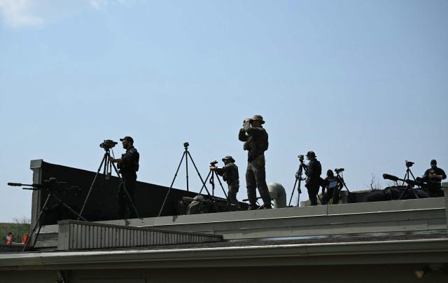 Secret Service members stand on a nearby rooftop as the US president speaks at the Burning Hills Amphitheatre in Medora, North Dakota, on July 1, 2026. (Photo by SAUL LOEB / AFP)