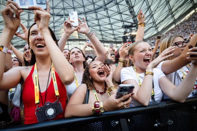 Fans cheer as they watch Puerto Rican singer Bad Bunny perform on stage at the Velodrome Stadium as part of his world tour, in Marseille, southern France, on July 01, 2026. (Photo by CLEMENT MAHOUDEAU / AFP)