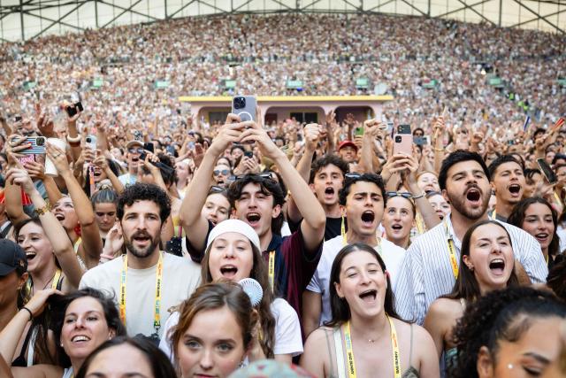 Fans react as they watch Puerto Rican singer Bad Bunny perform on stage at the Velodrome Stadium as part of his world tour, in Marseille, southern France, on July 01, 2026. (Photo by CLEMENT MAHOUDEAU / AFP)