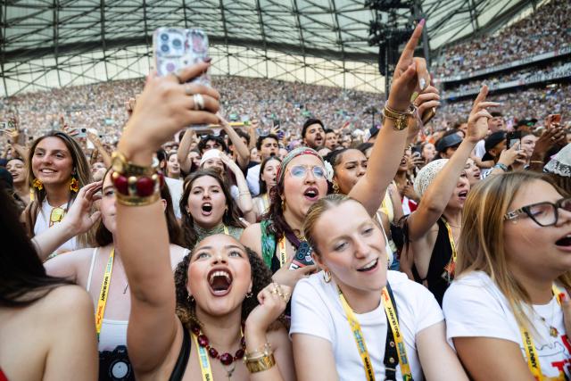 Fans react as they watch Puerto Rican singer Bad Bunny perform on stage at the Velodrome Stadium as part of his world tour, in Marseille, southern France, on July 01, 2026. (Photo by CLEMENT MAHOUDEAU / AFP)
