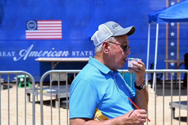 A man enjoys a semi-frozen beverage while visiting "The Great American State Fair" during a heatwave in Washington, DC, on July 1, 2026. Tens of millions of Americans sweltered under furnace-like temperatures this week as central and eastern cities hunkered down for a heat wave set to last through the July 4 holiday weekend. Dozens of local temperature records could be broken, the National Weather Service (NWS) warned, with temperatures in many places to surpass 100 degrees Fahrenheit (38 degrees Celsius) and high humidity pushing the heat index as high as 115 degrees. (Photo by Alex WROBLEWSKI / AFP)