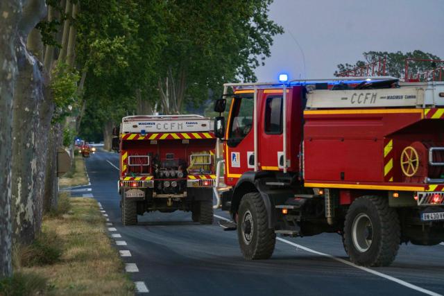 This photograph shows French firefighters wildland fire engines 'CCFM' (Camion Citerne Forestier Moyen) as a fire hits in Pouzols-Minervois, southwestern of France, on July 1, 2026. (Photo by Idriss Bigou-Gilles / AFP)