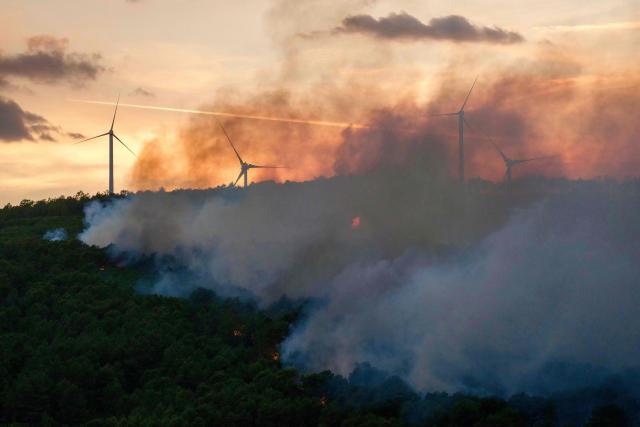 This photograph shows a wildfire next to wind turbines in Pouzols-Minervois, southwestern of France, July 1, 2026. (Photo by Idriss Bigou-Gilles / AFP)