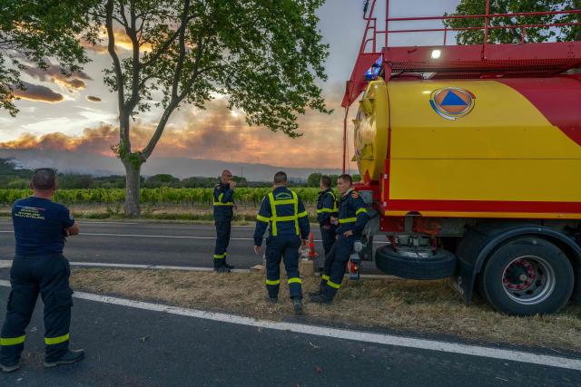 French civil security firefighters have a rest during a wildfire in Pouzols-Minervois, southwestern of France, on July 1, 2026. (Photo by Idriss Bigou-Gilles / AFP)