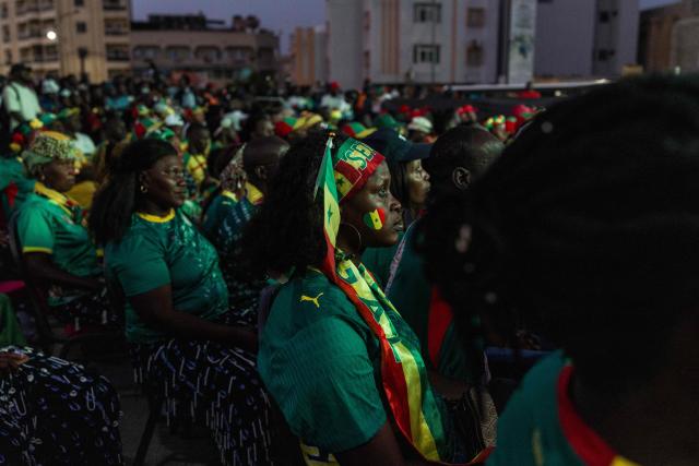 A Senegal supporter watches the 2026 World Cup round of 32 football match between Belgium and Senegal at the FIFA Fan Zone at the Place de l'Obelisque in Dakar on July 1, 2026. (Photo by Patrick Meinhardt / AFP)