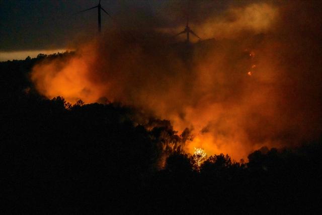 This photograph shows a wildfire next to wind turbines in Pouzols-Minervois, southwestern of France, July 1, 2026. (Photo by Idriss Bigou-Gilles / AFP)
