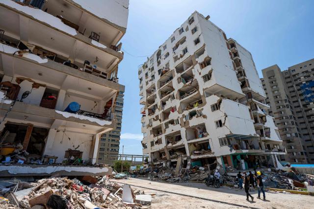 This photograph shows damaged buildings in Playa Grande neighborhood, La Guaira state, Venezuela, on July 1, 2026, following the June 24 twin earthquakes. Tens of thousands of people urgently need food and shelter in Venezuela due to the devastation from two huge earthquakes that killed more than 1,700 and injured 5,000, the UN said on June 30, 2026, as doctors warned of potential outbreaks of disease. (Photo by Miguel MEDINA / POOL / AFP)