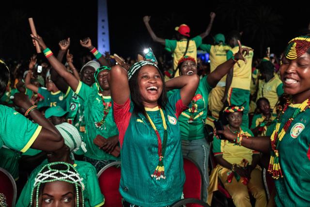 Senegal supporters celebrate Sengal's first goal as they watch the 2026 World Cup round of 32 football match between Belgium and Senegal at the FIFA Fan Zone at the Place de l'Obelisque in Dakar on July 1, 2026. (Photo by Patrick Meinhardt / AFP)