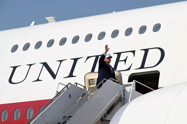US President Donald Trump waves while boarding Air Force One prior to departure from Bismarck Municipal Airport in Bismarck, North Dakota, July 1, 2026, following his visit to attend the grand opening of the Theodore Roosevelt Presidential Library. President Trump is on his first trip aboard the Boeing 747-8 that Qatar gifted the United States to use for executive travel. (Photo by SAUL LOEB / AFP)