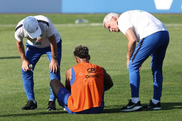 France's forward #20 Desire Doue (C) sits on the pitch in a training session at Bentley University in Waltham, near Boston, on July 1, 2026, during the 2026 World Cup football tournament. (Photo by FRANCK FIFE / AFP)