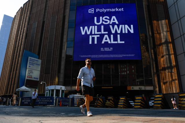 People walk by Madison Square Garden in New York on July 1, 2026. Increasing signs point to a mega-bash for the A-list celebrity couple Taylor Swift and Travis Kelce at Madison Square Garden this week. Rumors have run rampant for weeks that the 36-year-old pop superstar and the three-time NFL Super Bowl winner, both 36, could wed at the storied sports arena, home to the New York Knicks, the newly crowned NBA champions. (Photo by kena betancur / AFP)