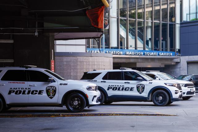 Police cruisers of the passenger railroad company Amtrak are parked outside the Madison Square Garden access to Penn Station in New York on July 1, 2026. Increasing signs point to a mega-bash for the A-list celebrity couple Taylor Swift and Travis Kelce at Madison Square Garden this week. Rumors have run rampant for weeks that the 36-year-old pop superstar and the three-time NFL Super Bowl winner, both 36, could wed at the storied sports arena, home to the New York Knicks, the newly crowned NBA champions. (Photo by kena betancur / AFP)