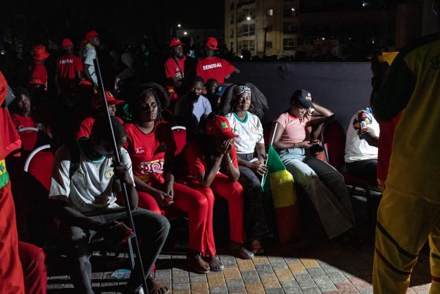 Senegal supporters react after their team lost the 2026 World Cup round of 32 football match against Belgium as they watch the game at the FIFA Fan Zone at the Place de l'Obelisque in Dakar on July 1, 2026. (Photo by Patrick Meinhardt / AFP)