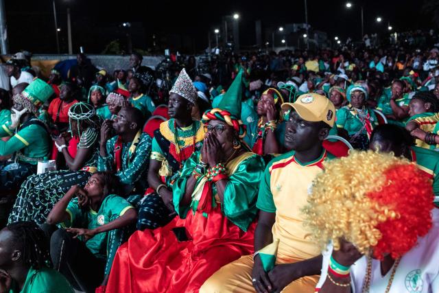 Senegal supporters react after their team lost the 2026 World Cup round of 32 football match against Belgium as they watch the game at the FIFA Fan Zone at the Place de l'Obelisque in Dakar on July 1, 2026. (Photo by Patrick Meinhardt / AFP)