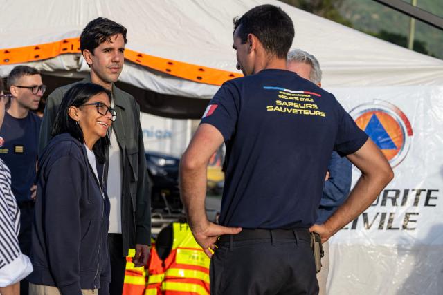 (L to R) Venezuela's interim President Delcy Rodriguez and Oliver Blanco, Venezuela's Vice Minister for Europe and North America, listen to Lieutenant-Colonel Vianney Labbe, head of the detachment of the French 7th Civil Security Training and Intervention Regiment (RIISC 7), during a visit to a temporary camp of the French Civil Security in La Guaira, La Guaira state, on July 1, 2026, following the June 24 twin earthquakes in Venezuela. Hope of finding more survivors faded on July 1 as Venezuela marked a week since twin earthquakes killed almost 2,300 people, while many who lived through the disaster were running desperately short on food. (Photo by Miguel MEDINA / POOL / AFP)