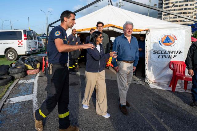 (L to R) Lieutenant-Colonel Vianney Labbe, head of the detachment of the French 7th Civil Security Training and Intervention Regiment (RIISC 7), Venezuela's interim President Delcy Rodriguez, Oliver Blanco, Venezuela's Vice Minister for Europe and North America, and French ambassador to Venezuela Emmanuel Pineda visit a temporary camp of the French Civil Security in La Guaira, La Guaira state, on July 1, 2026, following the June 24 twin earthquakes in Venezuela. Hope of finding more survivors faded on July 1 as Venezuela marked a week since twin earthquakes killed almost 2,300 people, while many who lived through the disaster were running desperately short on food. (Photo by Miguel MEDINA / POOL / AFP)