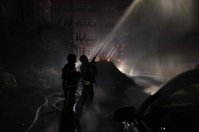 Ukrainian firefighters work to extinguish a fire in a building hit by a drone during a Russian air attack on Kyiv, early on July 2, 2026. AFP journalists in the central and eastern districts of Kyiv heard more than a dozen explosions, as the city's Mayor Vitali Klitschko said on Telegram that "Kyiv is under attack from ballistic missiles and UAVs". (Photo by Roman PILIPEY / AFP)