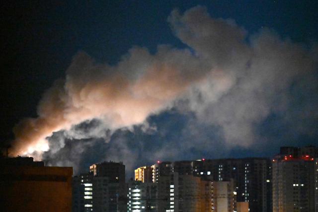 Smoke rises during a Russian missile strike on the Ukrainian capital Kyiv on July 2, 2026, amid the Russian invasion in Ukraine. Russian missile and drone strikes rocked Kyiv early on July 2, setting off fires and wounding at least five people, after President Volodymyr Zelensky warned that Moscow was preparing a "massive attack". (Photo by Sergei SUPINSKY / AFP)