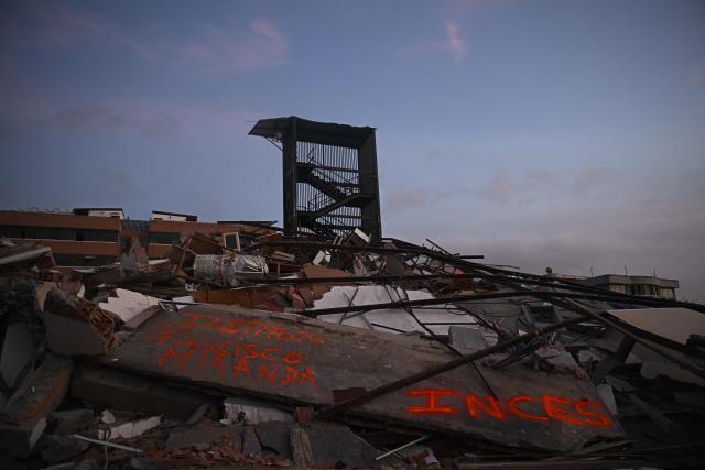 A collapsed building is seen with a stairwell still standing in Catia La Mar, La Guaira State, Venezuela on July 1, 2026, following the June 24 twin earthquakes. Hope of finding more survivors faded on July 1 as Venezuela marked a week since twin earthquakes killed almost 2,300 people, while many who lived through the disaster were running desperately short on food. (Photo by Federico PARRA / AFP)