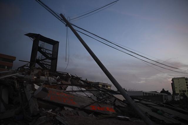 Collapsed buildings are seen with a stairwell still standing in Catia La Mar, La Guaira State, Venezuela on July 1, 2026, following the June 24 twin earthquakes. Hope of finding more survivors faded on July 1 as Venezuela marked a week since twin earthquakes killed almost 2,300 people, while many who lived through the disaster were running desperately short on food. (Photo by Federico PARRA / AFP)
