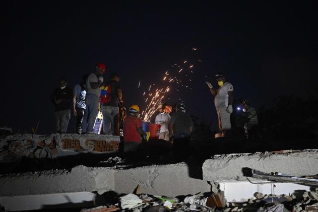 Workers clear debris at the site of a collapsed building in Catia La Mar, La Guaira State, Venezuela on July 1, 2026, following the June 24 twin earthquakes. Hope of finding more survivors faded on July 1 as Venezuela marked a week since twin earthquakes killed almost 2,300 people, while many who lived through the disaster were running desperately short on food. (Photo by Federico PARRA / AFP)