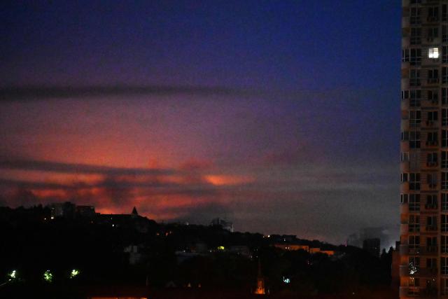 A glow from an explosion is seen during a Russian missile strike on the Ukrainian capital Kyiv on July 2, 2026, amid the Russian invasion in Ukraine. Russian missile and drone strikes rocked Kyiv early on July 2, setting off fires and wounding at least five people, after President Volodymyr Zelensky warned that Moscow was preparing a "massive attack". (Photo by Sergei SUPINSKY / AFP)