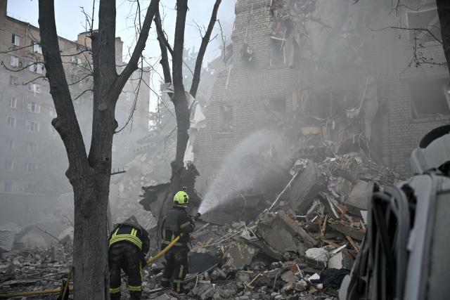 Rescuers extinguish a fire and work in a damaged residential building  following missile strikes on the Ukrainian capital of Kyiv on July 2, 2026, amid the Russian invasion of Ukraine. Russian missile and drone strikes rocked Kyiv early on July 2, killing at least eight people and wounding dozens, after President Volodymyr Zelensky warned that Moscow was preparing a "massive attack". (Photo by Genya Savilov / AFP)