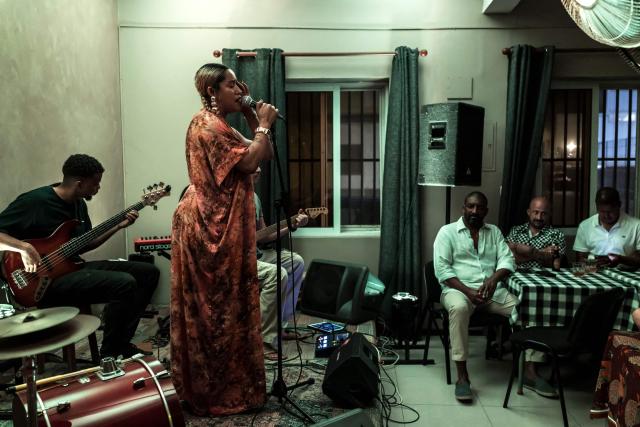 Cape Verdean singer Ceuzany Pires sings during a concert at a bar in Mindelo, on May 26, 2026. Barefoot, arms raised to the sky and overcome with emotion, Ceuzany delivers with her powerful voice the flagship song from her latest album dedicated to the fight against domestic violence, sending shivers through the audience packed into a bar in Mindelo, on the island of Sгo Vicente.
She is compared to the great Cesбria Йvora, the “barefoot diva” who introduced two traditional Cape Verdean music genres to the world: morna (soft, nostalgic melodies) and coladeira (faster-paced rhythm). (Photo by PATRICK MEINHARDT / AFP)