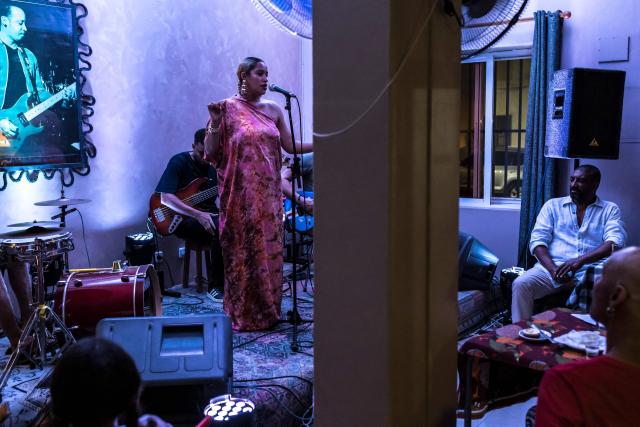 Cape Verdean singer Ceuzany Pires sings during a concert at a bar in Mindelo, on May 26, 2026. Barefoot, arms raised to the sky and overcome with emotion, Ceuzany delivers with her powerful voice the flagship song from her latest album dedicated to the fight against domestic violence, sending shivers through the audience packed into a bar in Mindelo, on the island of Sгo Vicente.
She is compared to the great Cesбria Йvora, the “barefoot diva” who introduced two traditional Cape Verdean music genres to the world: morna (soft, nostalgic melodies) and coladeira (faster-paced rhythm). (Photo by PATRICK MEINHARDT / AFP)
