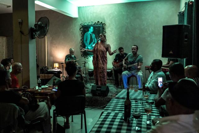 Cape Verdean singer Ceuzany Pires sings during a concert at a bar in Mindelo, on May 26, 2026. Barefoot, arms raised to the sky and overcome with emotion, Ceuzany delivers with her powerful voice the flagship song from her latest album dedicated to the fight against domestic violence, sending shivers through the audience packed into a bar in Mindelo, on the island of Sгo Vicente.
She is compared to the great Cesбria Йvora, the “barefoot diva” who introduced two traditional Cape Verdean music genres to the world: morna (soft, nostalgic melodies) and coladeira (faster-paced rhythm). (Photo by PATRICK MEINHARDT / AFP)