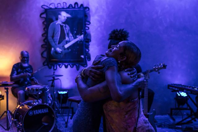 Cape Verdean singer Ceuzany Pires (R) hugs one of her friends during a concert at a bar in Mindelo, on May 26, 2026. Barefoot, arms raised to the sky and overcome with emotion, Ceuzany delivers with her powerful voice the flagship song from her latest album dedicated to the fight against domestic violence, sending shivers through the audience packed into a bar in Mindelo, on the island of Sгo Vicente.
She is compared to the great Cesбria Йvora, the “barefoot diva” who introduced two traditional Cape Verdean music genres to the world: morna (soft, nostalgic melodies) and coladeira (faster-paced rhythm). (Photo by PATRICK MEINHARDT / AFP)