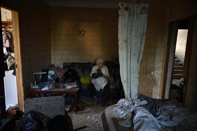Local resident Valentina, 86, sits in her flat in a damaged residential building following missile strikes on the Ukrainian capital of Kyiv on July 2, 2026, amid the Russian invasion in Ukraine. Russian missile and drone strikes rocked Kyiv early on July 2, killing at least eight people and wounding dozens, after President Volodymyr Zelensky warned that Moscow was preparing a "massive attack". (Photo by Genya Savilov / AFP)