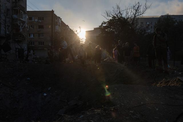 Residents gather next to a crater in front of a residential building damaged following a Russian air attack on the Ukrainian capital of Kyiv on July 2, 2026, amid the Russian invasion in Ukraine. Russian missile and drone strikes rocked Kyiv early on July 2, killing at least eight people and wounding dozens, after President Volodymyr Zelensky warned that Moscow was preparing a "massive attack". (Photo by Roman PILIPEY / AFP)