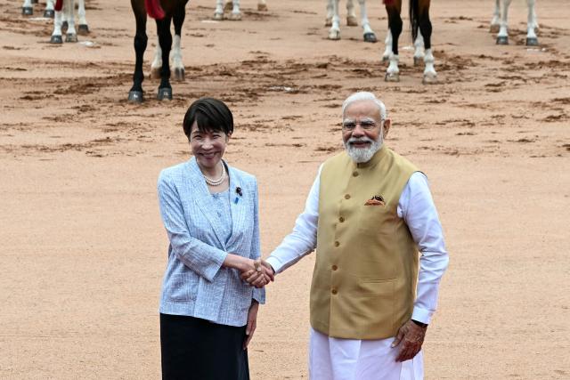 Japan's Prime Minister Sanae Takaichi (L) shakes hands with India's Prime Minister Narendra Modi during her ceremonial reception at India's presidential palace, Rashtrapati Bhavan, in New Delhi on July 2, 2026. (Photo by Sajjad HUSSAIN / AFP)