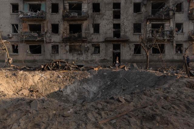 A person walks from a residential building damaged following a Russian air attack on the Ukrainian capital of Kyiv on July 2, 2026, amid the Russian invasion in Ukraine. Russian missile and drone strikes rocked Kyiv early on July 2, killing at least eight people and wounding dozens, after President Volodymyr Zelensky warned that Moscow was preparing a "massive attack". (Photo by Roman PILIPEY / AFP)