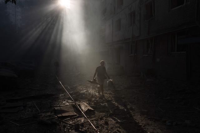 A person walks next a residential building damaged following a Russian air attack on the Ukrainian capital of Kyiv on July 2, 2026, amid the Russian invasion in Ukraine. Russian missile and drone strikes rocked Kyiv early on July 2, killing at least eight people and wounding dozens, after President Volodymyr Zelensky warned that Moscow was preparing a "massive attack". (Photo by Roman PILIPEY / AFP)