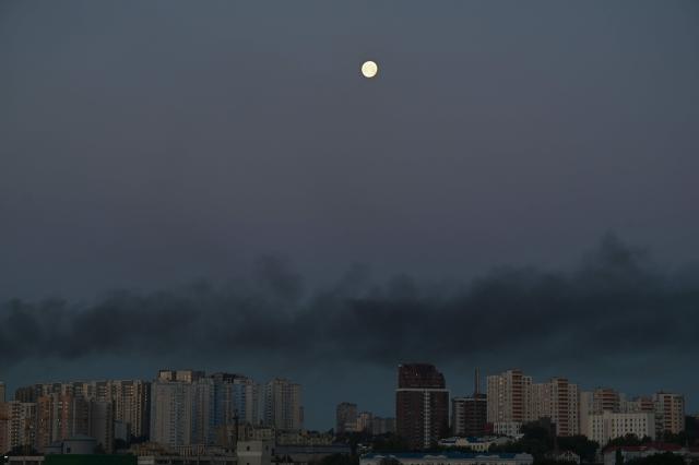 The moon is pictured above smoke in the air during Russian missile strikes on the Ukrainian capital Kyiv on July 2, 2026, amid the Russian invasion in Ukraine. Russian missile and drone strikes rocked Kyiv early on July 2, killing at least eight people and wounding dozens, after President Volodymyr Zelensky warned that Moscow was preparing a "massive attack". (Photo by Sergei SUPINSKY / AFP)