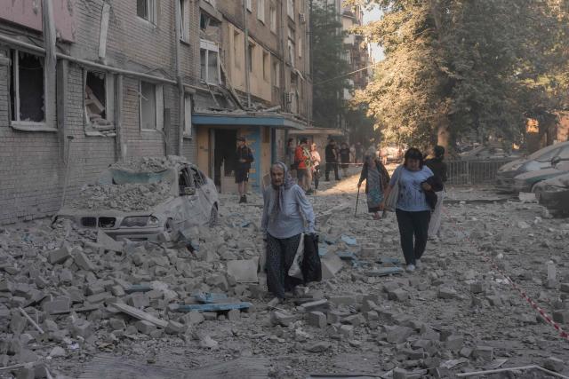 An elderly woman walks through the rubble at the site of a residential building damaged following a Russian air attack on the Ukrainian capital of Kyiv on July 2, 2026, amid the Russian invasion in Ukraine. A barrage of Russian missiles and drones killed at least 13 people in the Ukrainian capital of Kyiv, officials said on July 2, as Ukraine urged its allies to send more air defence systems. (Photo by Roman PILIPEY / AFP)