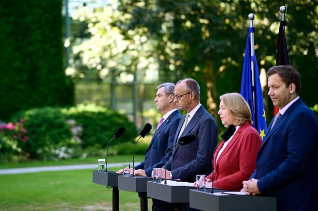 (L-R) German Finance Minister and Vice Chancellor Lars Klingbeil (SPD), German Chancellor Friedrich Merz (CDU), German Minister for Labour and Social Affairs Baerbel Bas (SPD) and Bavaria's State Premier and leader of the conservative Christian Social Union (CSU) Markus Soeder address a press confernce, on July 2, 2026 in the garden of the Chancellery in Berlin, one day after their coalition committee consultations on a major package of reforms. (Photo by Tobias SCHWARZ / AFP)
