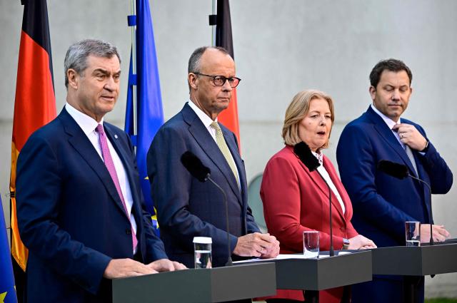 (L-R) German Finance Minister and Vice Chancellor Lars Klingbeil (SPD), German Chancellor Friedrich Merz (CDU), German Minister for Labour and Social Affairs Baerbel Bas (SPD) and Bavaria's State Premier and leader of the conservative Christian Social Union (CSU) Markus Soeder address a press confernce, on July 2, 2026 in the garden of the Chancellery in Berlin, one day after their coalition committee consultations on a major package of reforms. (Photo by Tobias SCHWARZ / AFP)