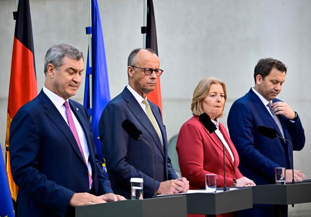 (L-R) German Finance Minister and Vice Chancellor Lars Klingbeil (SPD), German Chancellor Friedrich Merz (CDU), German Minister for Labour and Social Affairs Baerbel Bas (SPD) and Bavaria's State Premier and leader of the conservative Christian Social Union (CSU) Markus Soeder address a press confernce, on July 2, 2026 in the garden of the Chancellery in Berlin, one day after their coalition committee consultations on a major package of reforms. (Photo by Tobias SCHWARZ / AFP)