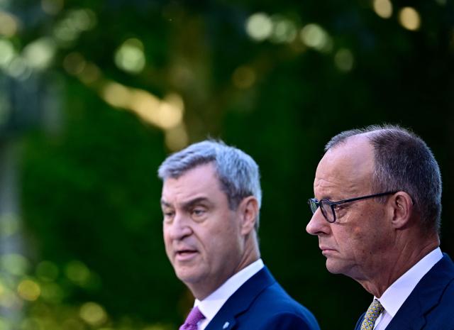 (L-R) Bavaria's State Premier and leader of the conservative Christian Social Union (CSU) Markus Soeder and German Chancellor Friedrich Merz (CDU)  address a press conference, on July 2, 2026 in the garden of the Chancellery in Berlin, one day after their coalition committee consultations on a major package of reforms. (Photo by Tobias SCHWARZ / AFP)